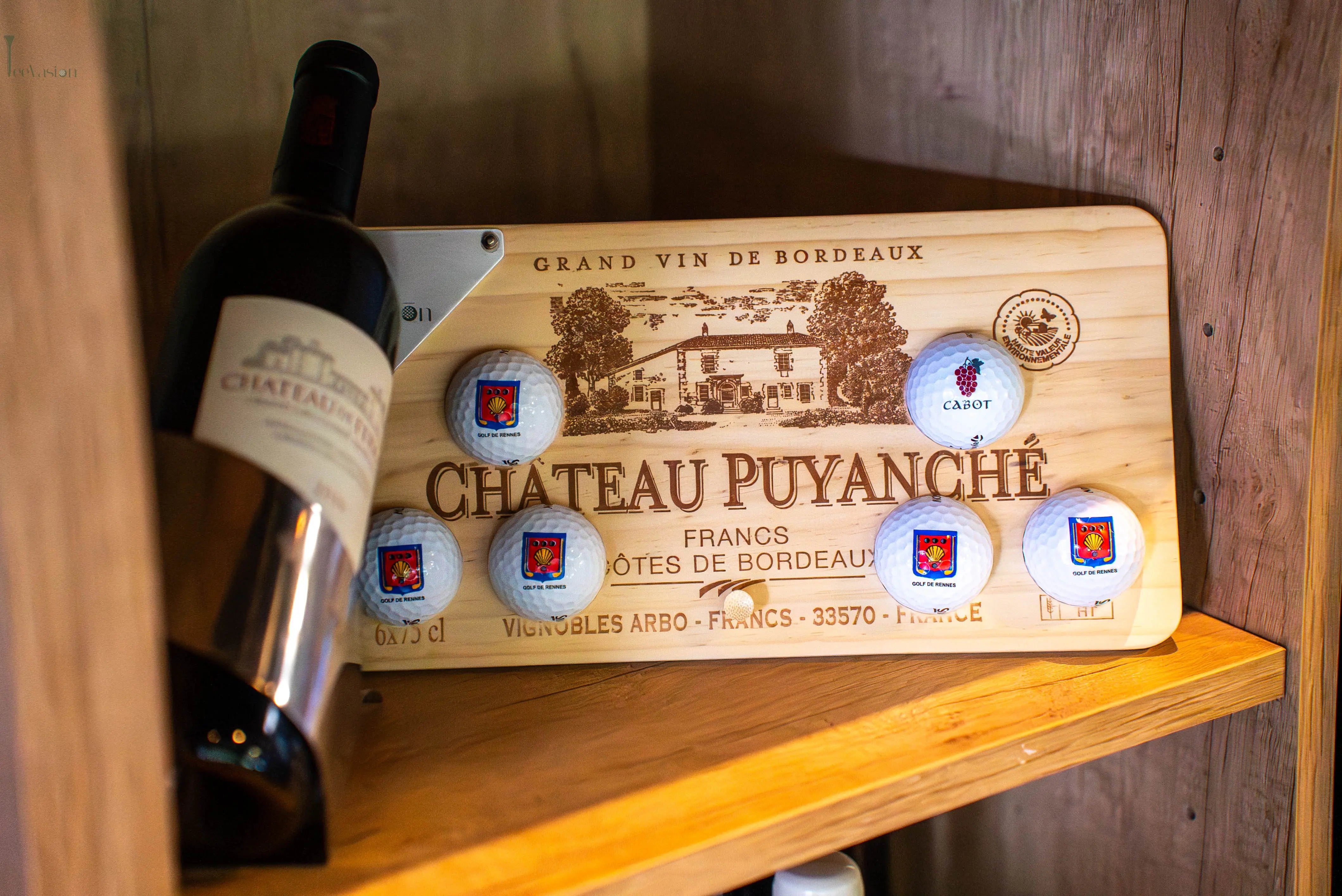 Un support 6 balles sur caisse de vin installe dans la cave d'un restaurant a cote d'une bouteille